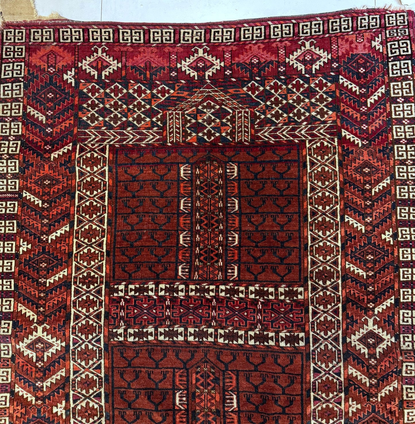 Detail of the rich madder red background and its luminous vegetable dye color.