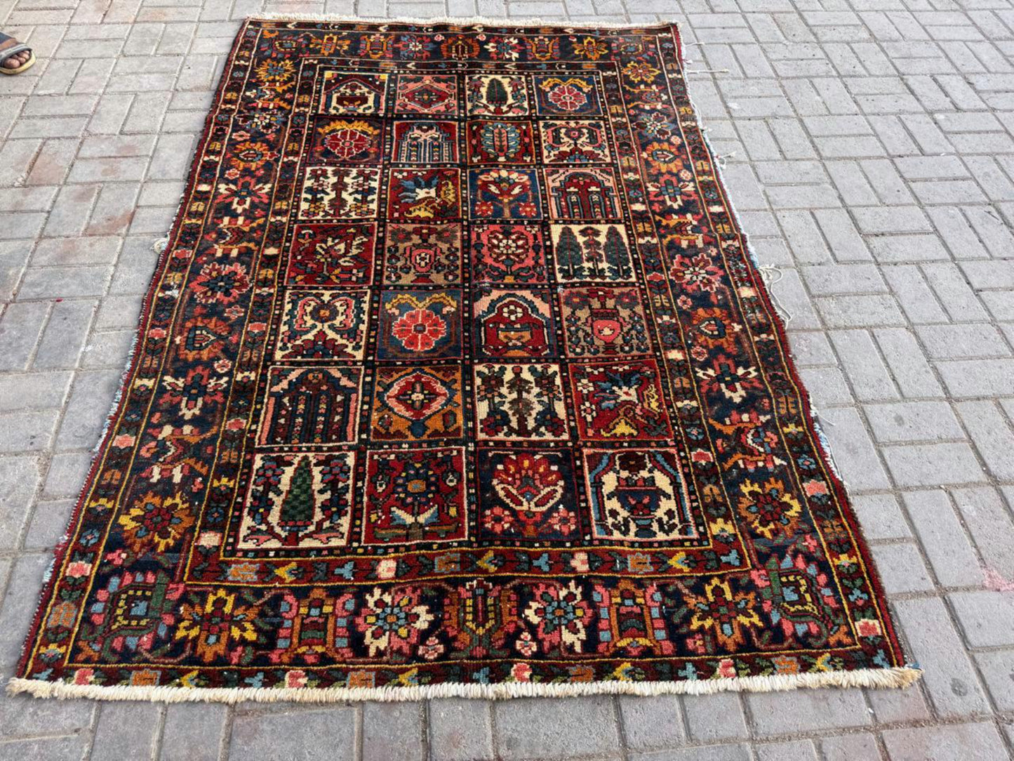 Detail of the deep indigo and terracotta red colors in the geometric patterns.