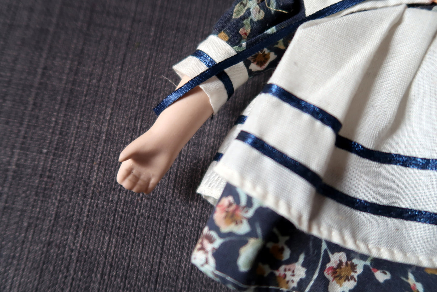 Retro porcelain doll in a charming blue and white gown
