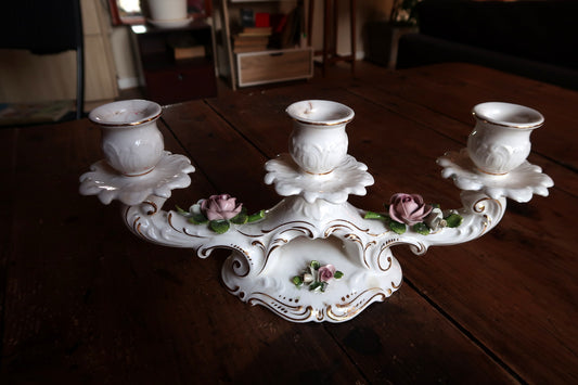 Mid-century Bavarian porcelain triple candle holder decorated with Rococo floral bouquets and gilded accents.