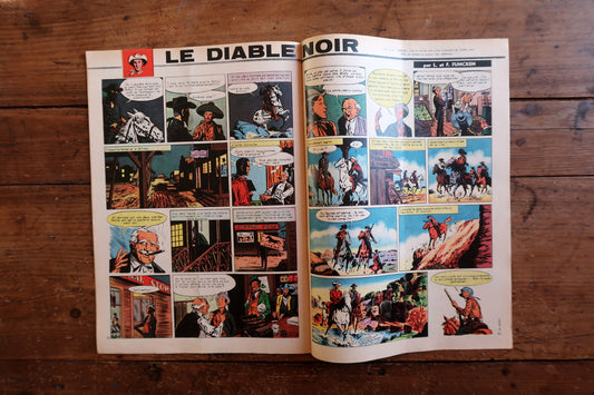 Close-up of the cover art on a 1959 French Tintin comic book magazine showing a striking racing scene with classic cars and the iconic Tintin header.