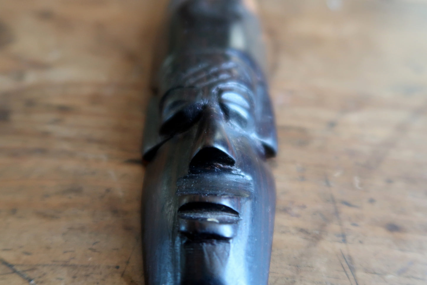 Vintage African wall mask featuring elongated proportions and horned headdress