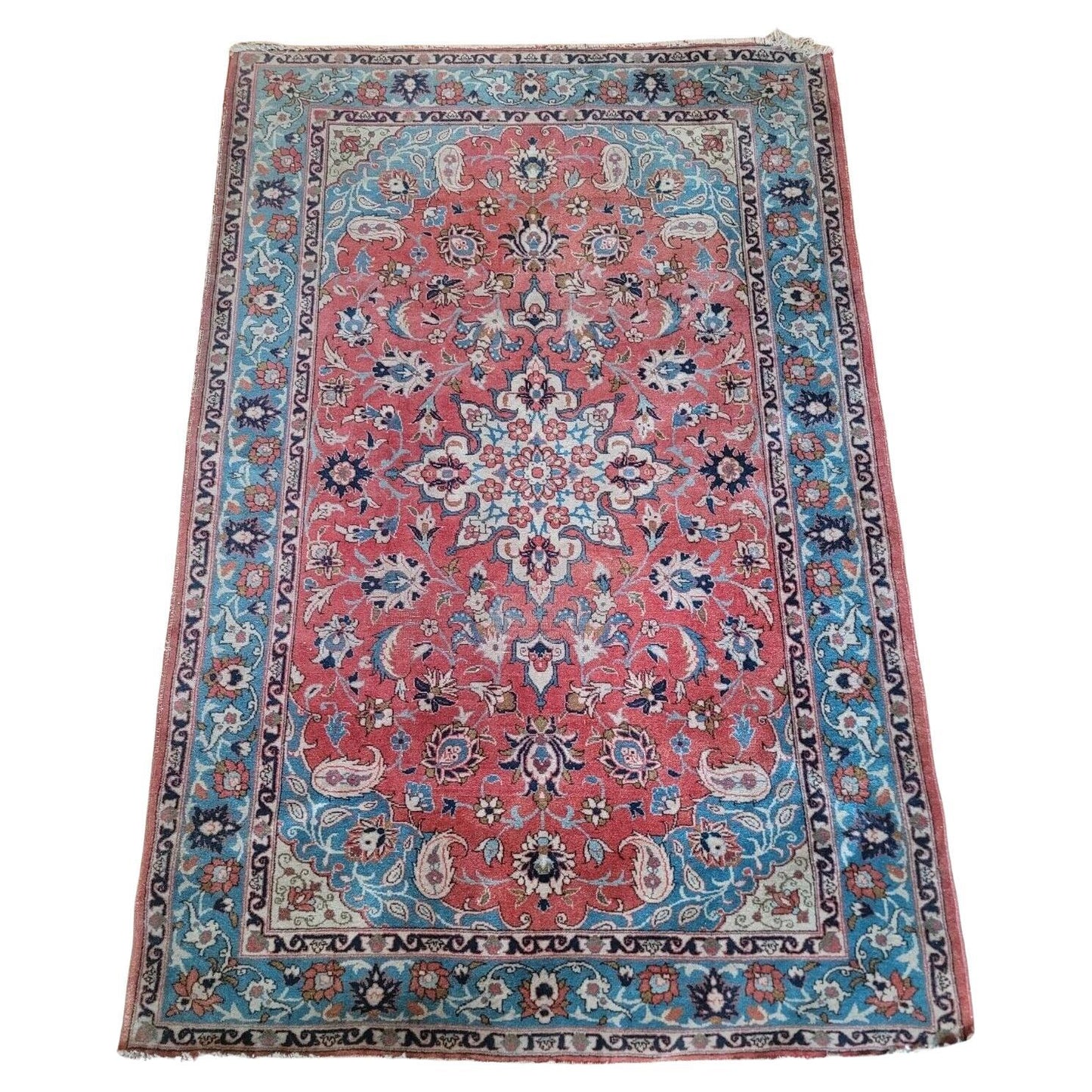 Close-up of intricate floral motifs on a Persian Tabriz rug