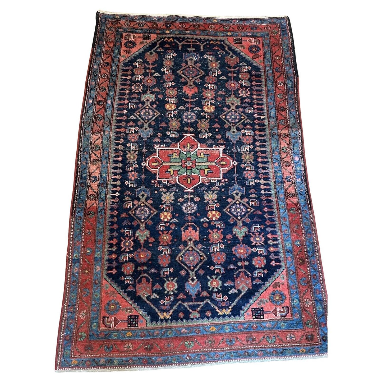 Close-up of intricate geometric motifs on a Persian Hamadan rug