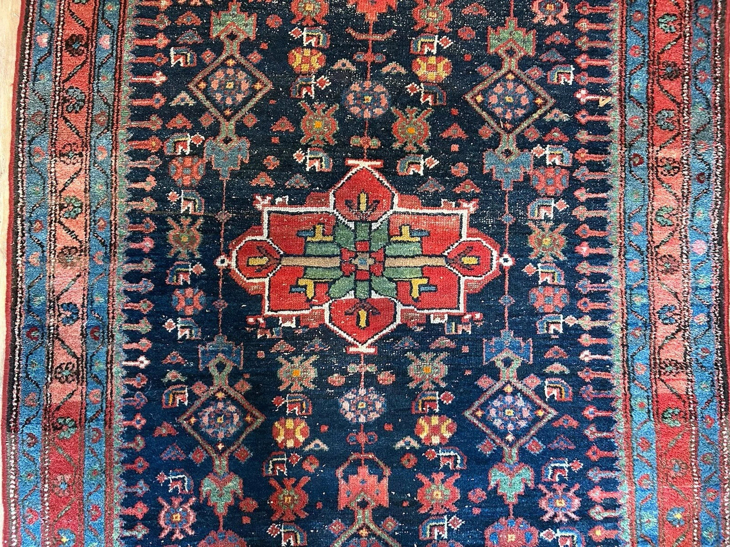 Hand-knotted Persian rug with symmetrical patterns and vibrant colors