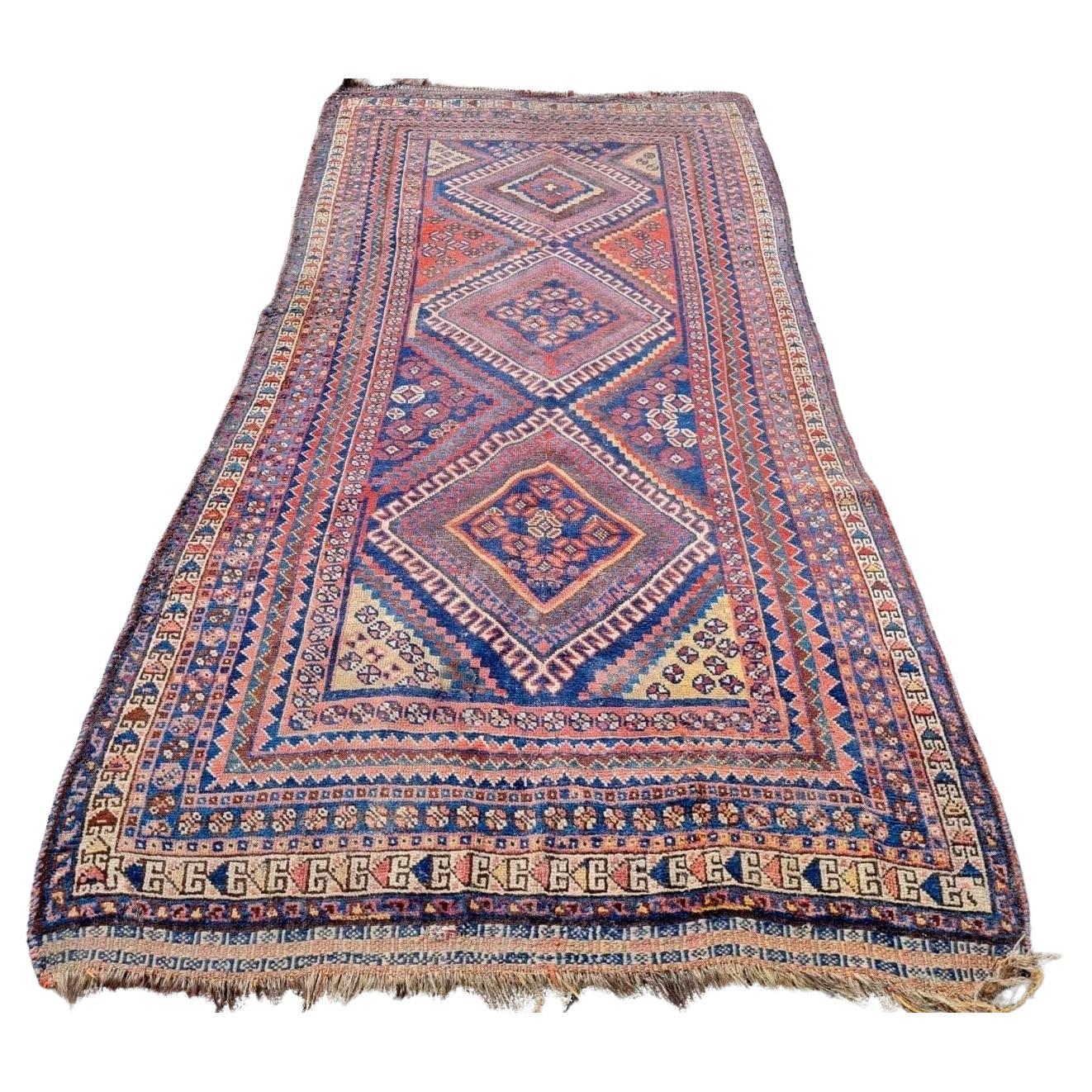 Antique Persian Gashkai rug with red and navy geometric patterns