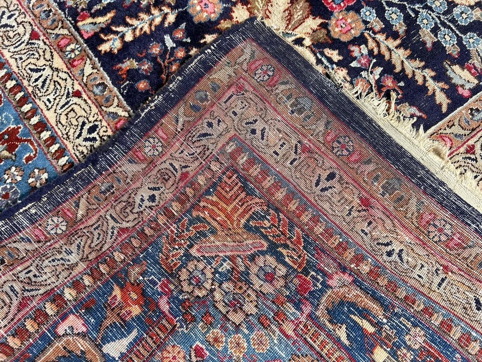 Close-up of floral vines on 1920s Kashan rug