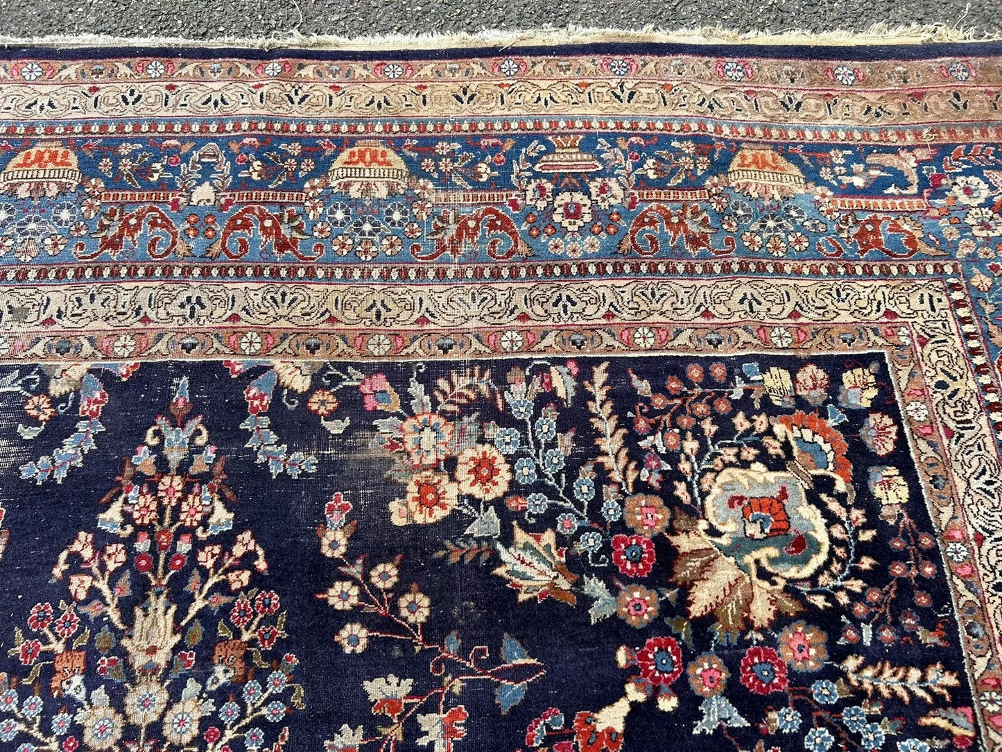 Soft red field and navy border on antique Persian carpet