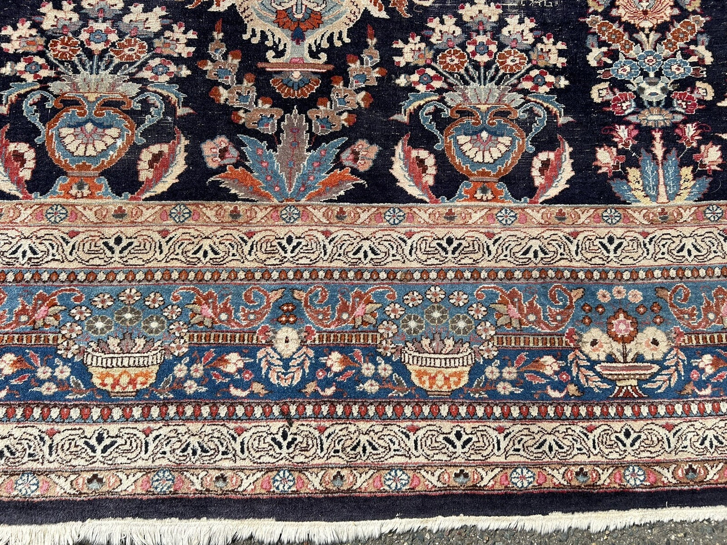 Aged patina and color variation in antique rug