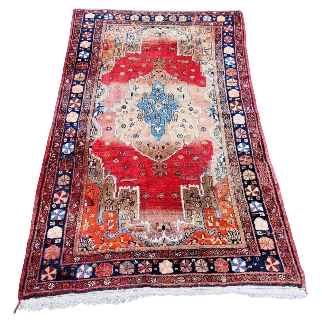 Antique Persian Malayer rug with red field and geometric motifs