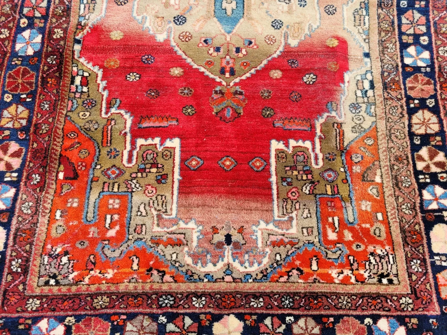 Detailed close-up of midnight blue border on Malayer rug