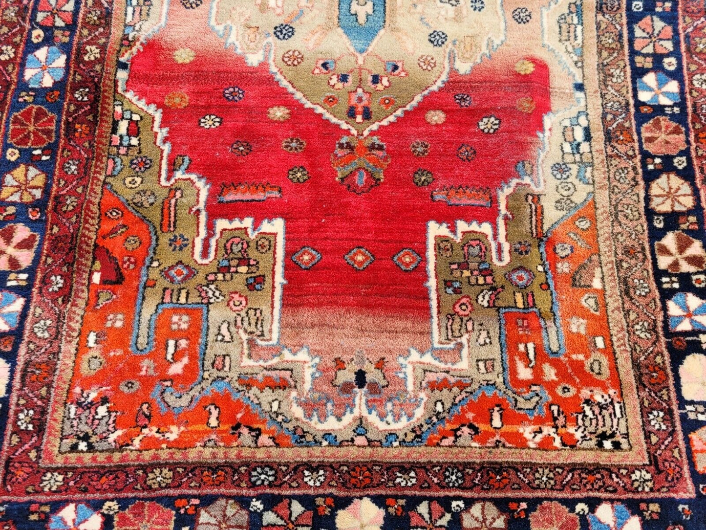 Stylized floral medallions on antique Persian rug