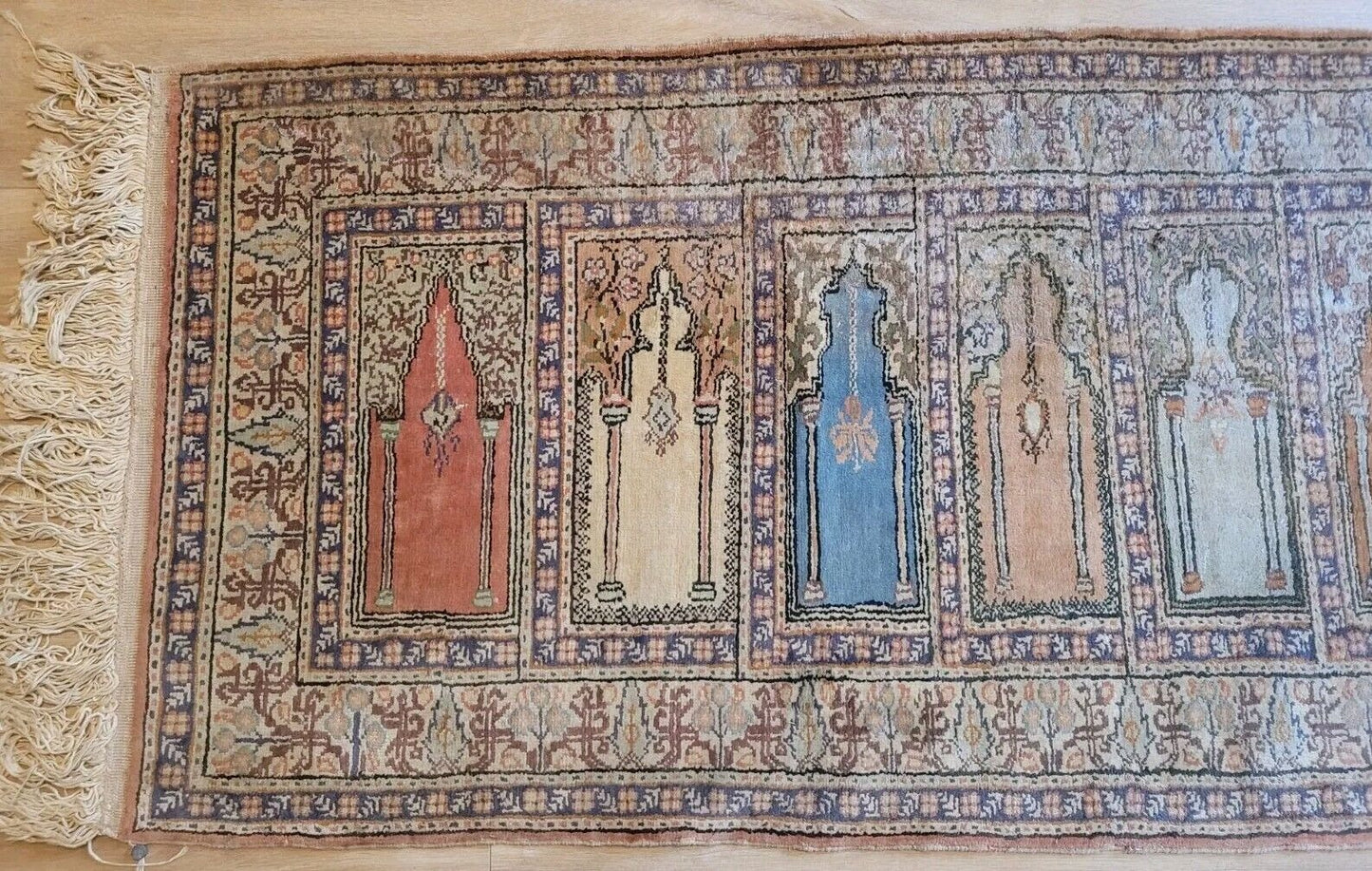 Traditional Turkish silk rug with faded green and blue