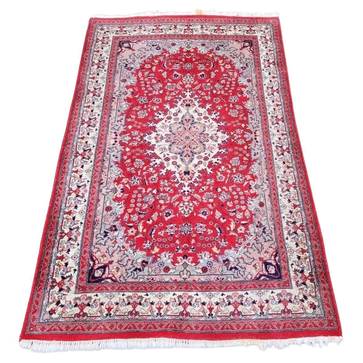 Hand-knotted Persian Sarouk rug with a central medallion.