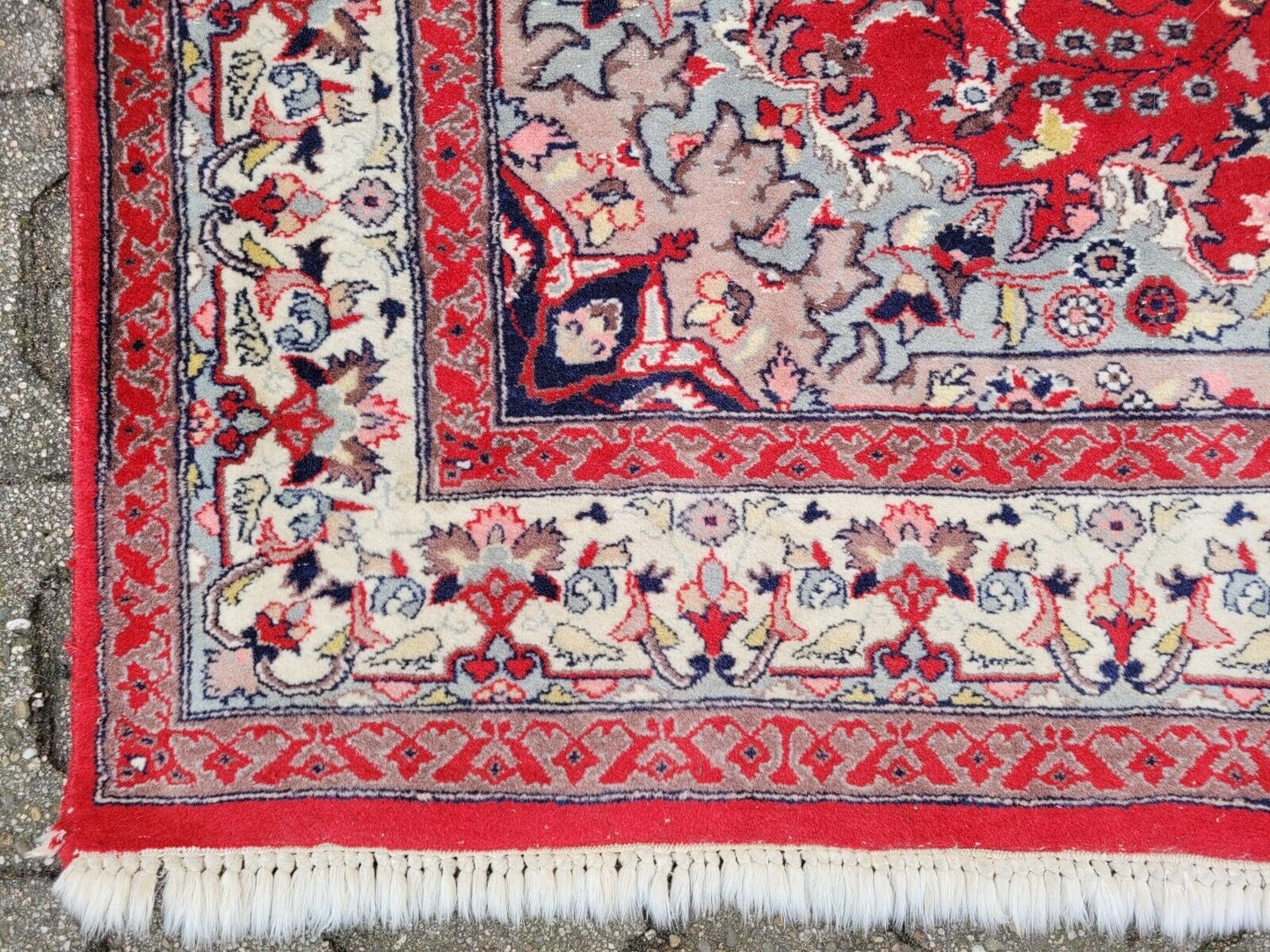 Persian rug with an intricate, dense border pattern.