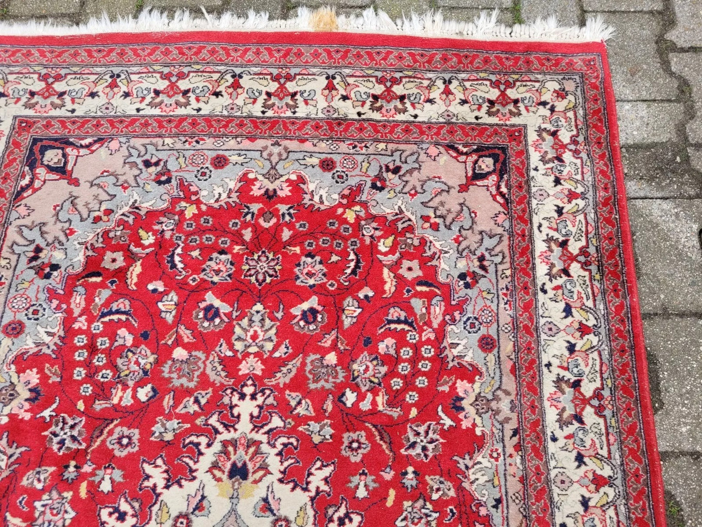 Front view of a Sarouk rug with a detailed floral design.