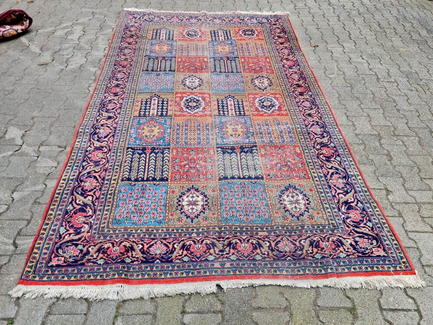 Colorful patterned rug on a stone pavement