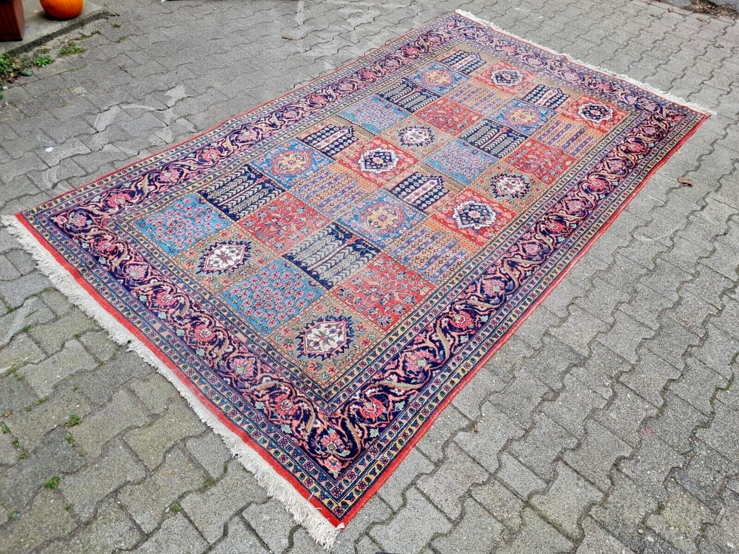 Hand-knotted tribal rug with an intricate panel layout.