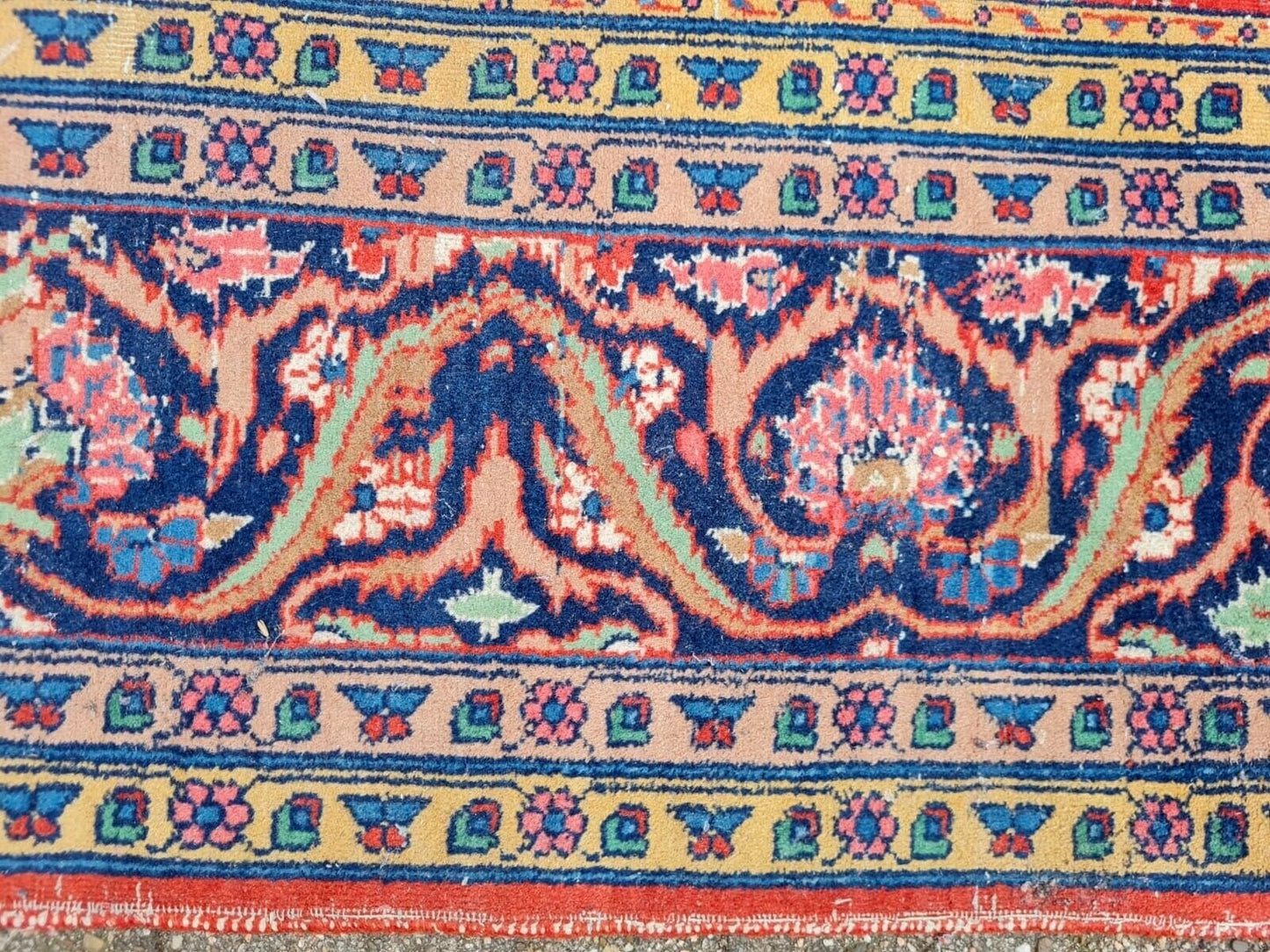 Antique rug with vibrant hues in each rectangular panel.