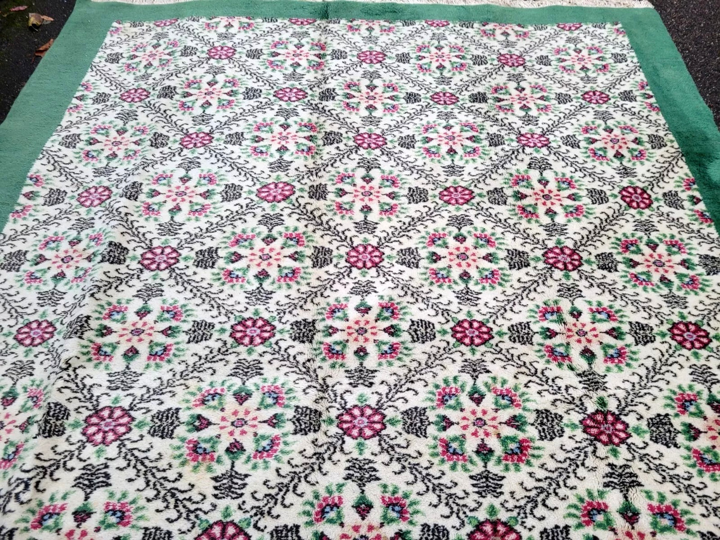 Hand-knotted Sivas rug with delicate black scrolling foliage.