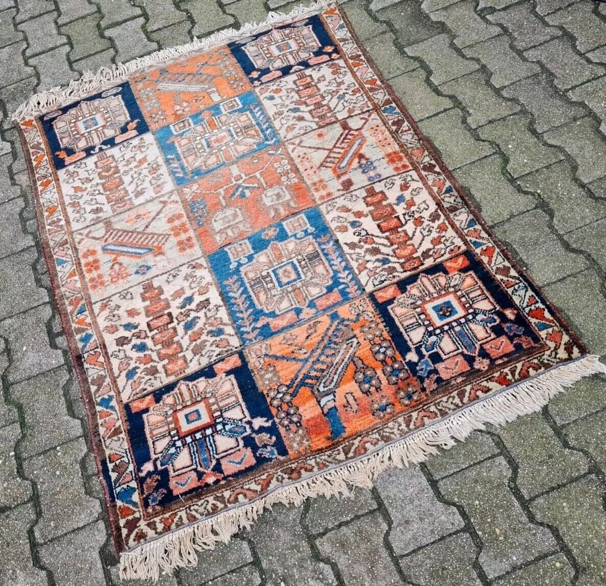 Hand-knotted rug showing touches of navy and gold tones.