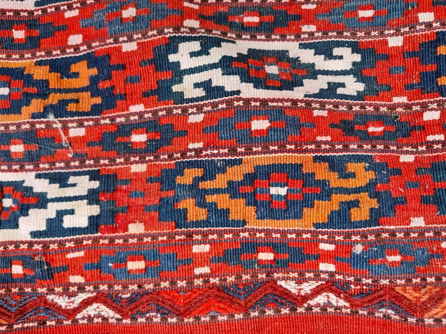 Vintage Kilim in striking deep red and navy blue colors.