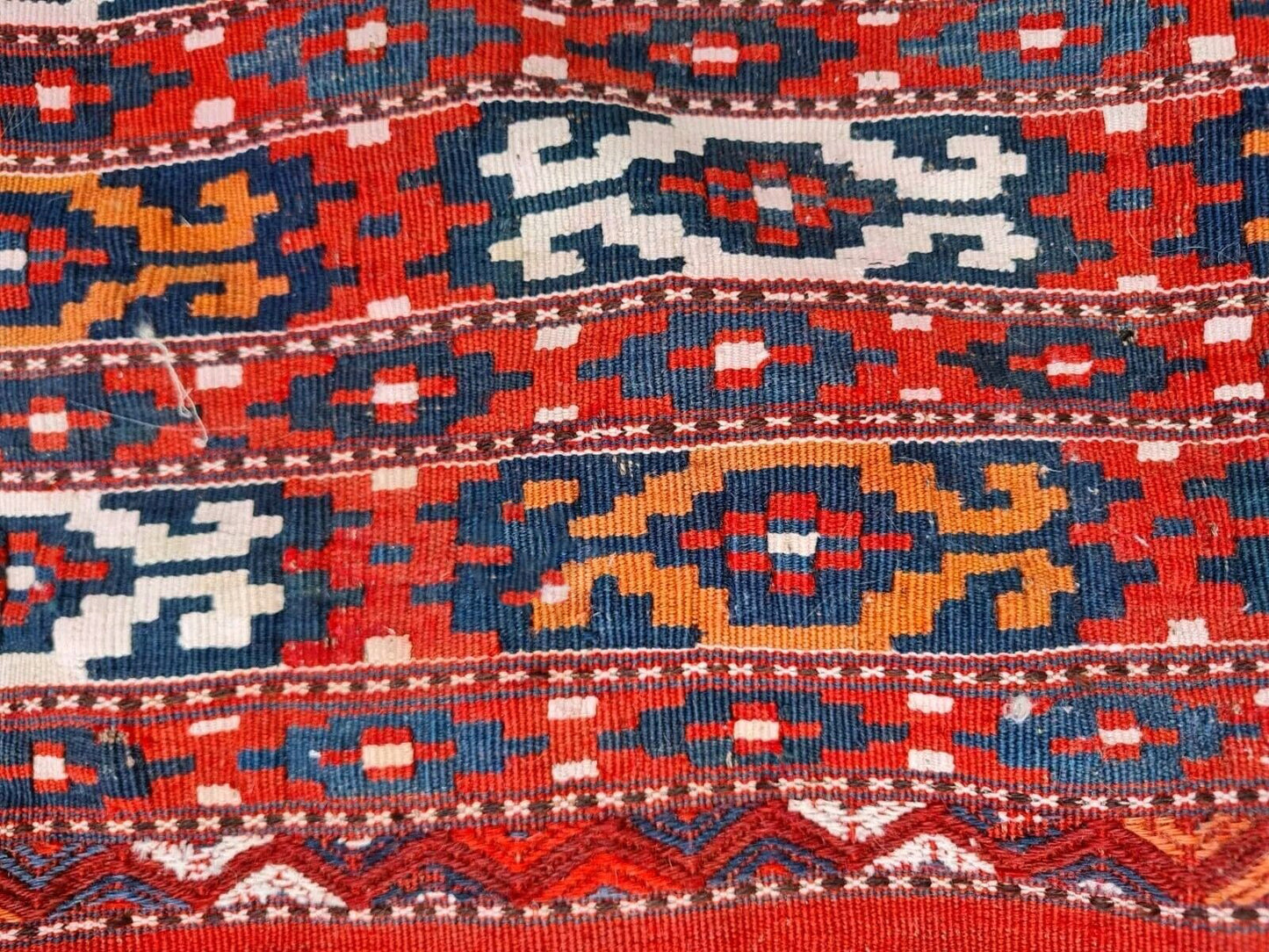 Handwoven wool rug with minor wear and charming patina.
