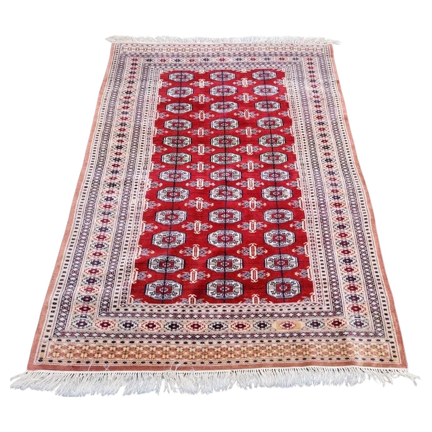 Handmade vintage Bukhara rug with classic gul motifs