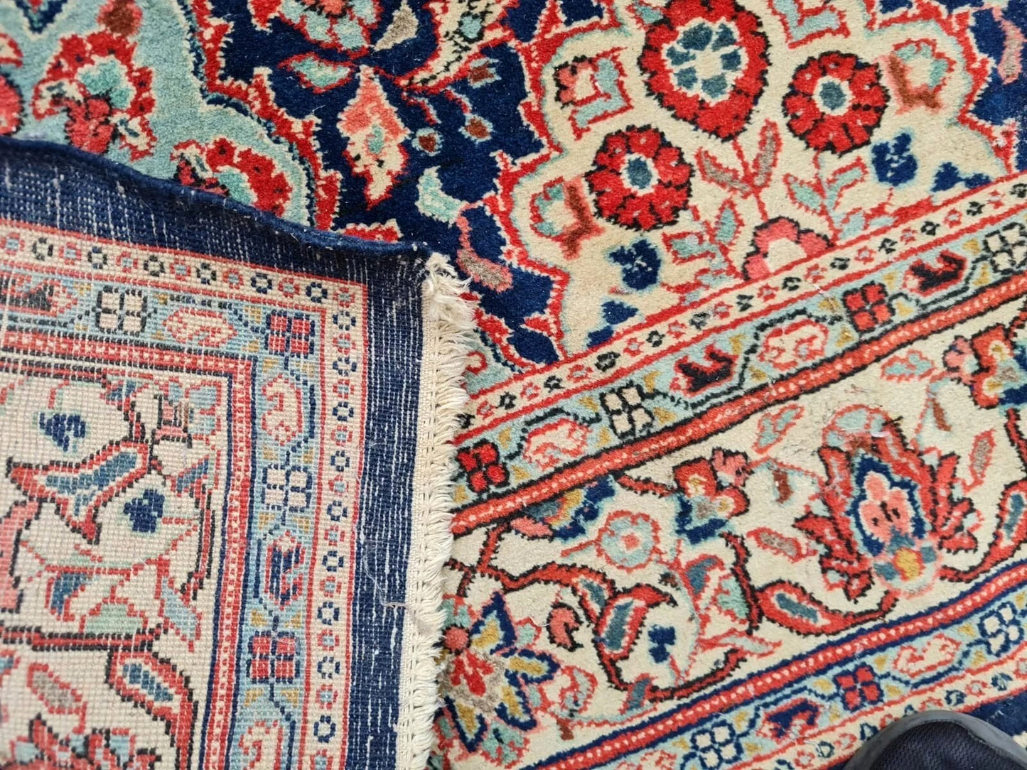 Central medallion in red and light blue on 1920s rug