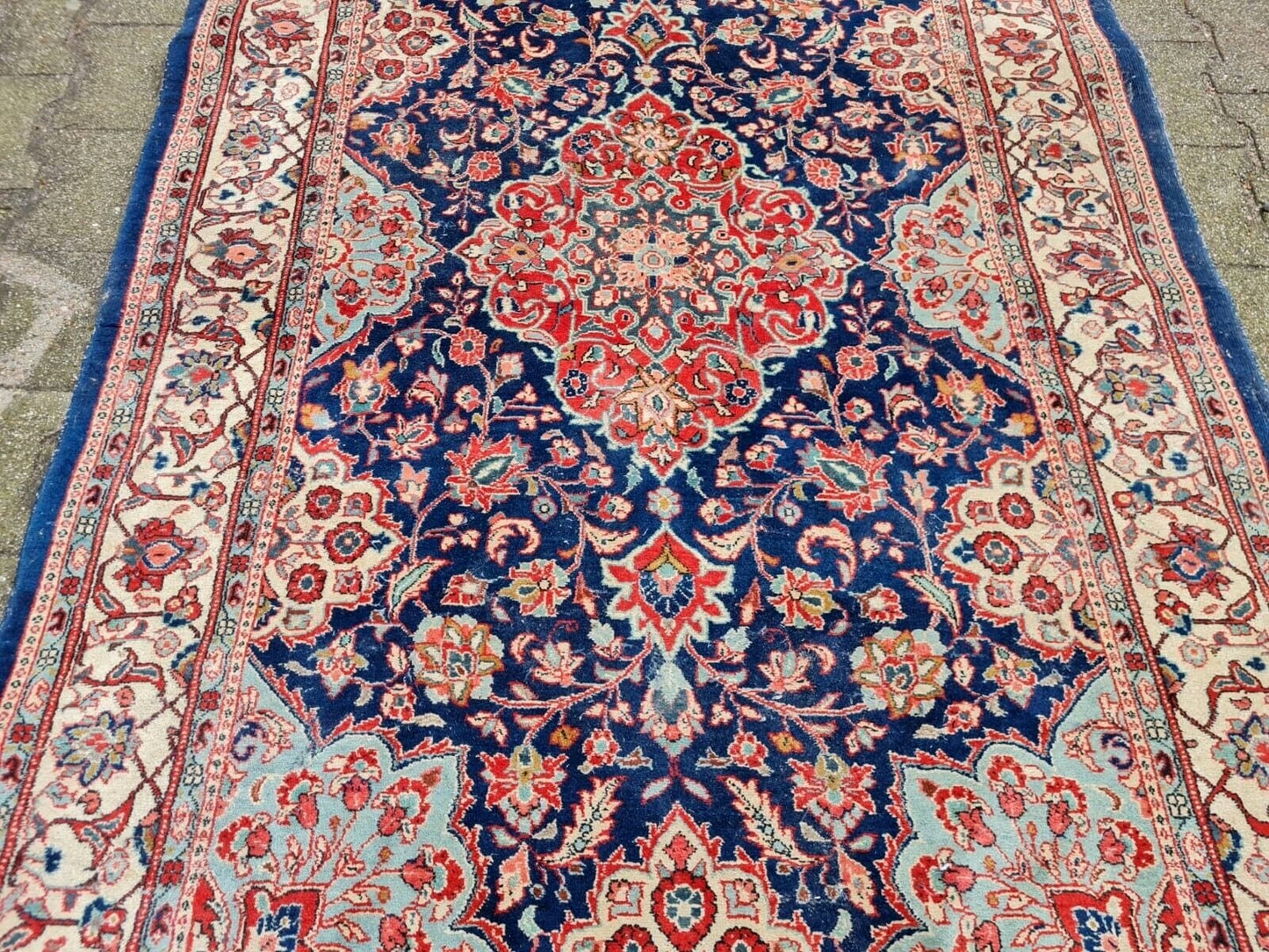 Floral and vine detail on antique wool rug