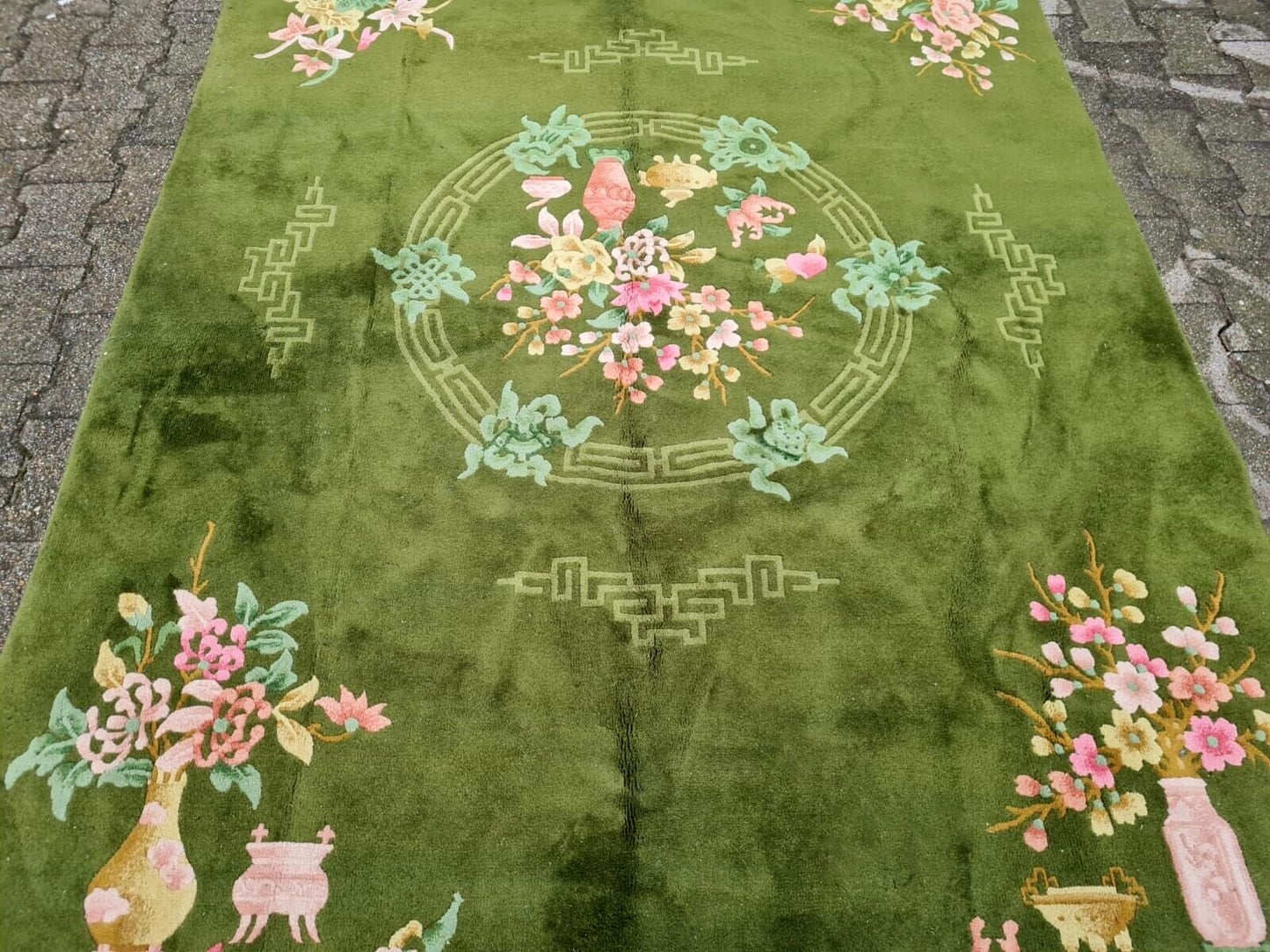 Pastel pink and cream floral detail on mid-century rug
