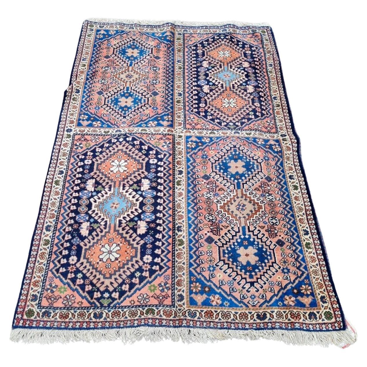 Vintage Persian Luri rug with deep red field and geometric patterns