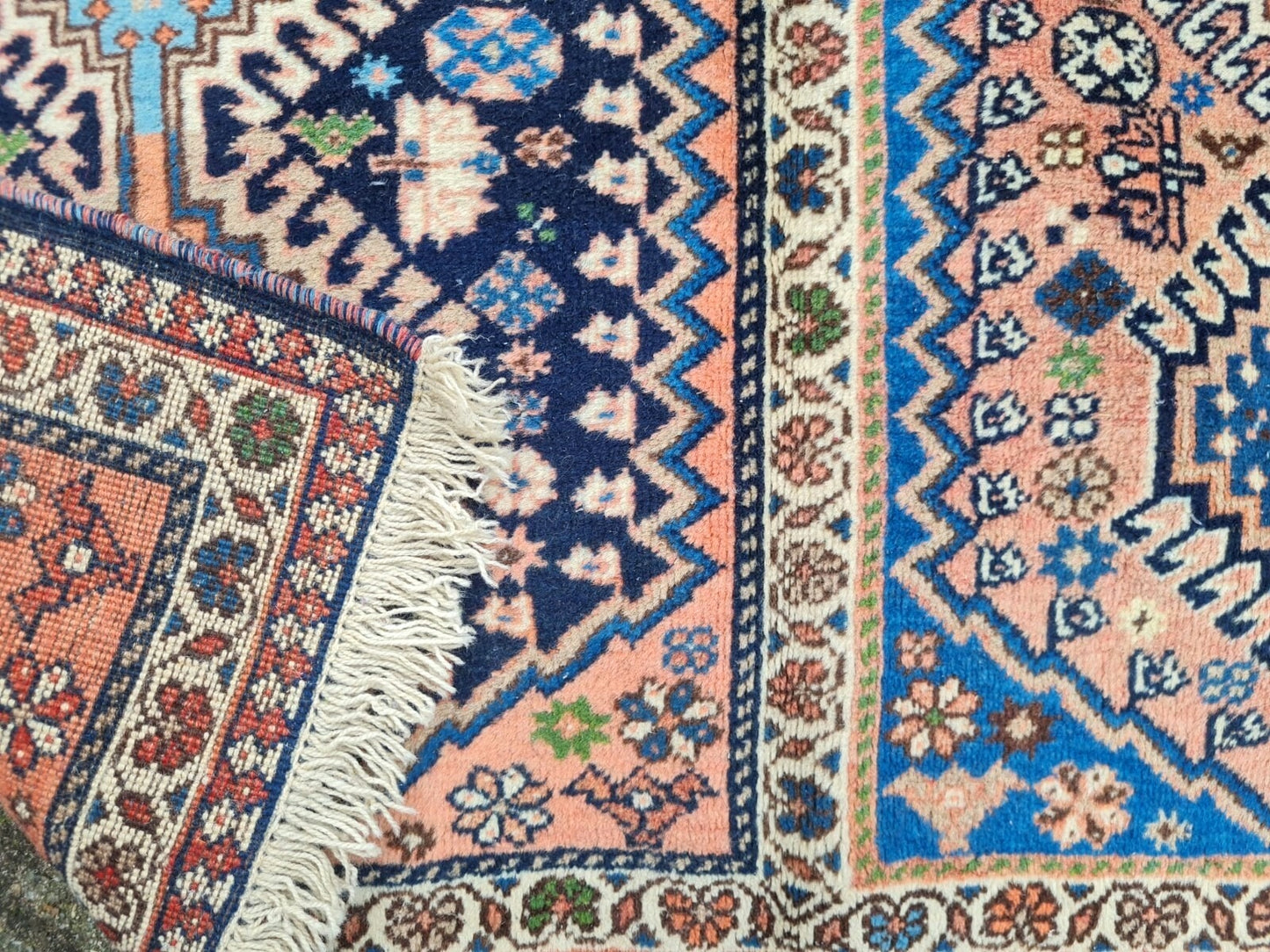 Bold tribal motifs and borders on Luri rug