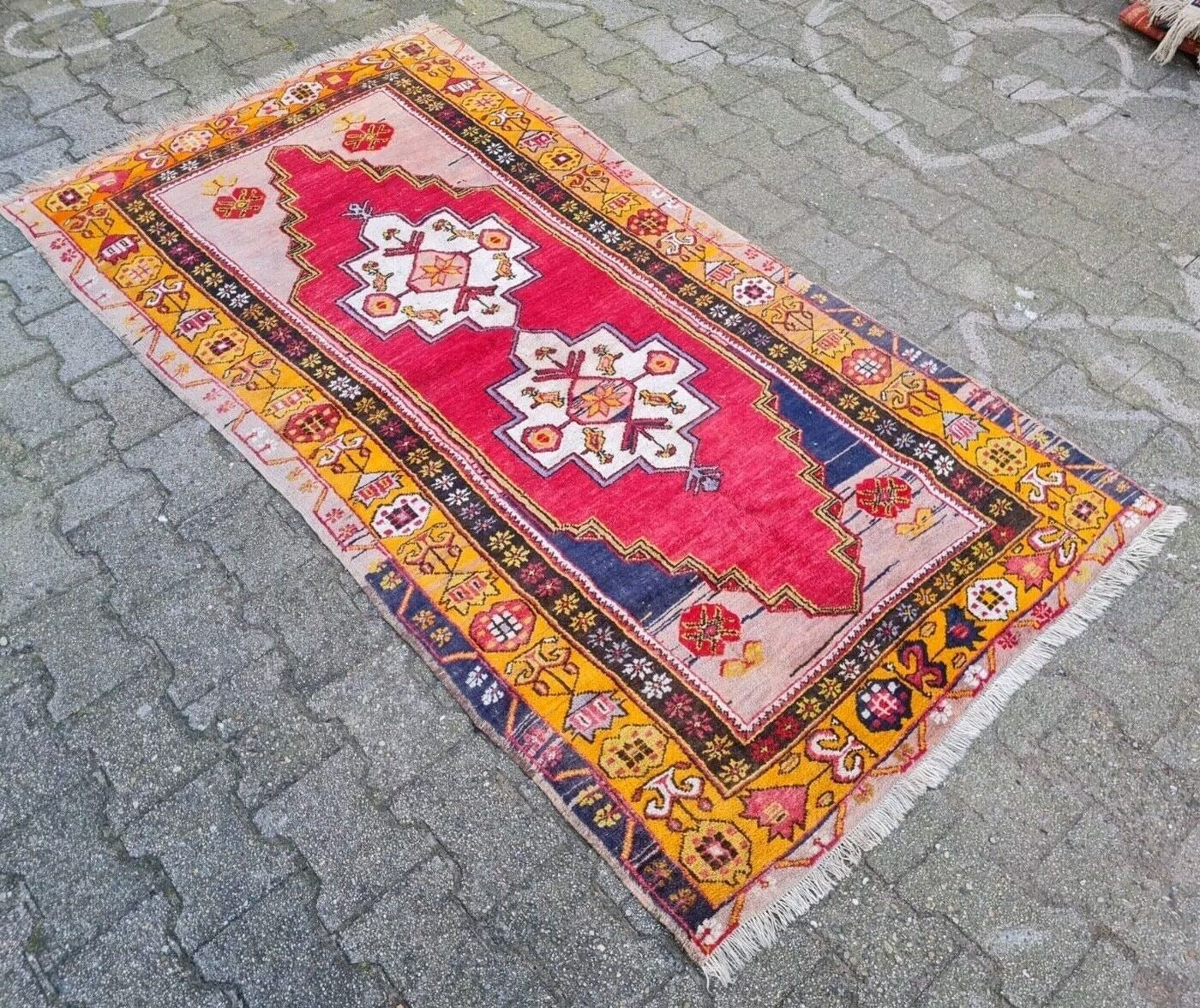 detailed blue and orange tribal motifs on Anatolian rug