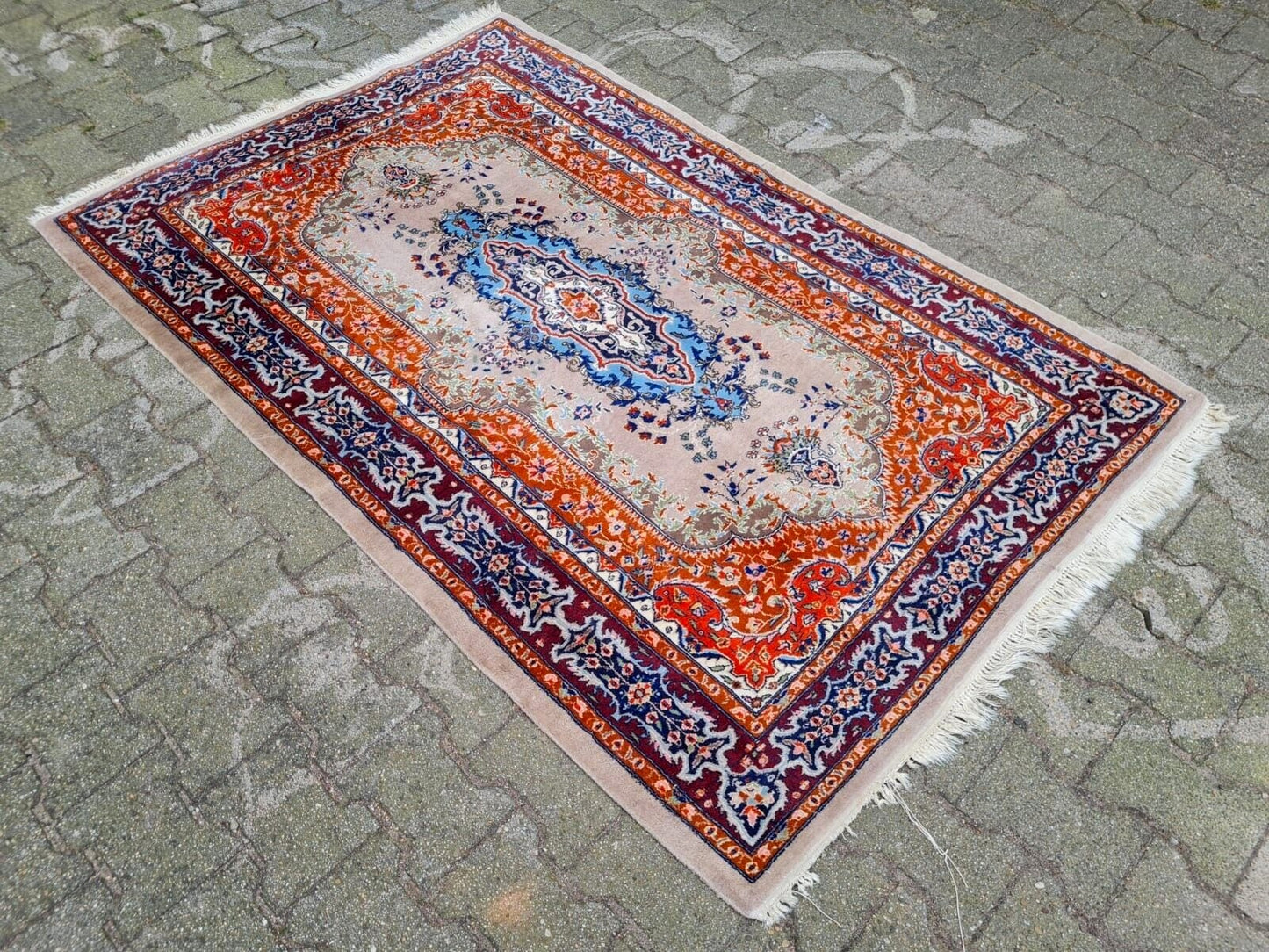 Cream field rug with blue and orange accents