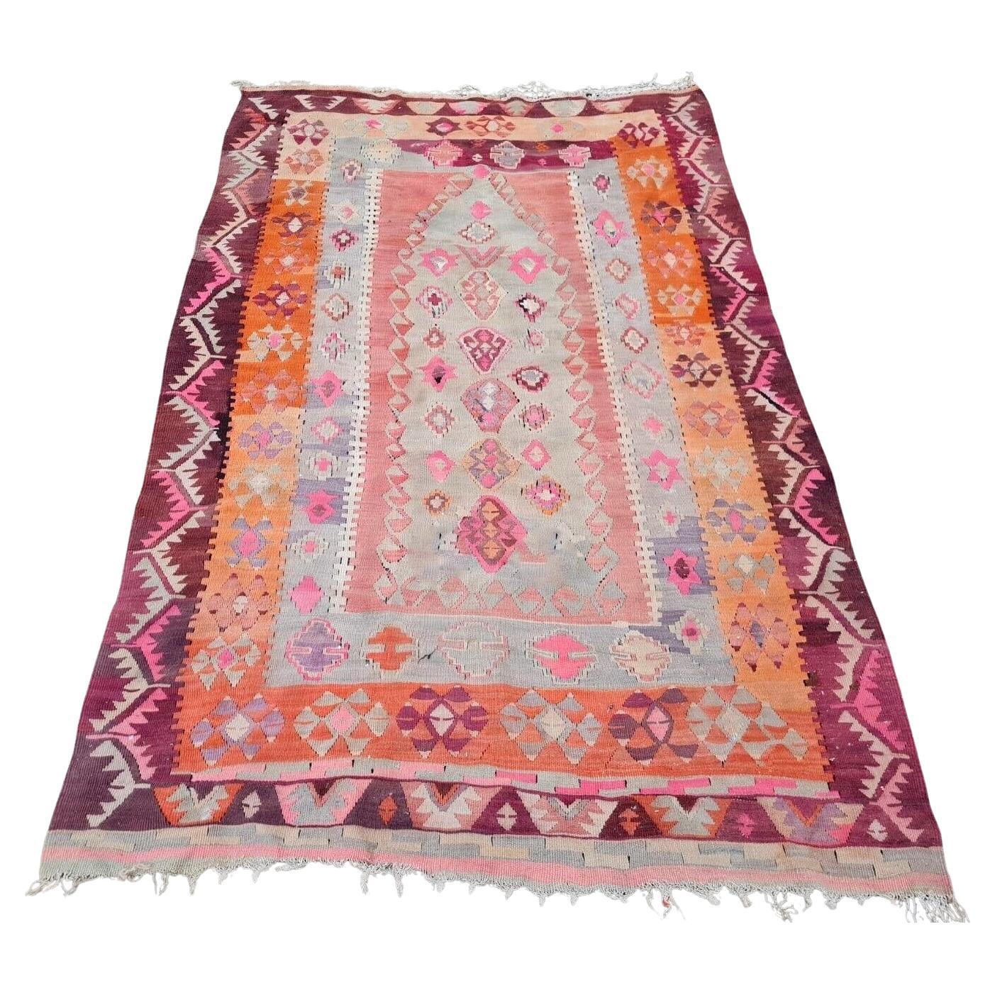 Close-up of diamond motif in pink and orange on vintage Anatolian kilim