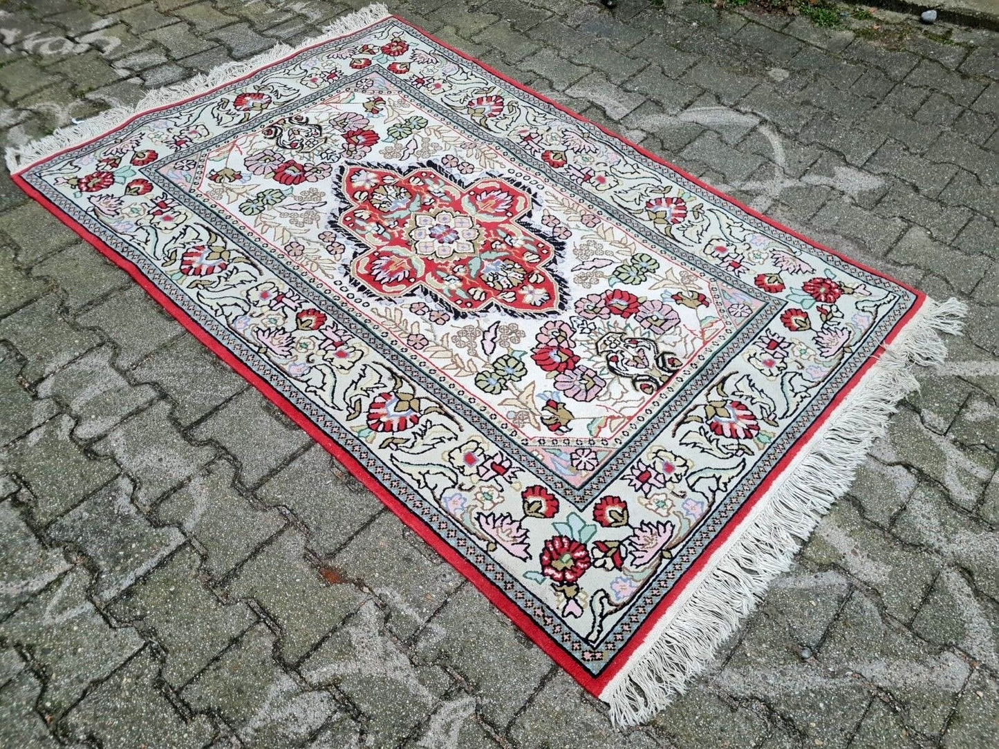 Border detail with floral scrollwork on Persian rug