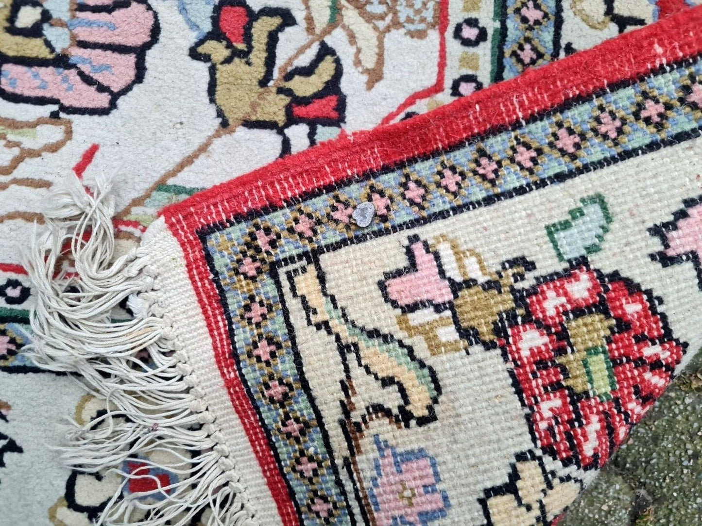 Deep red wool pile with blue and ivory botanical patterns