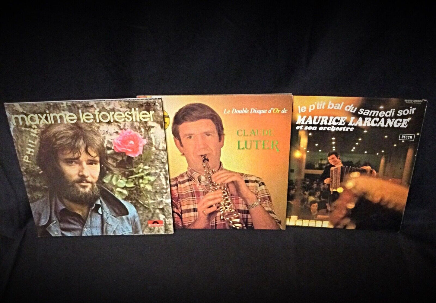Side view showing the edge of the three vinyl records in their sleeves