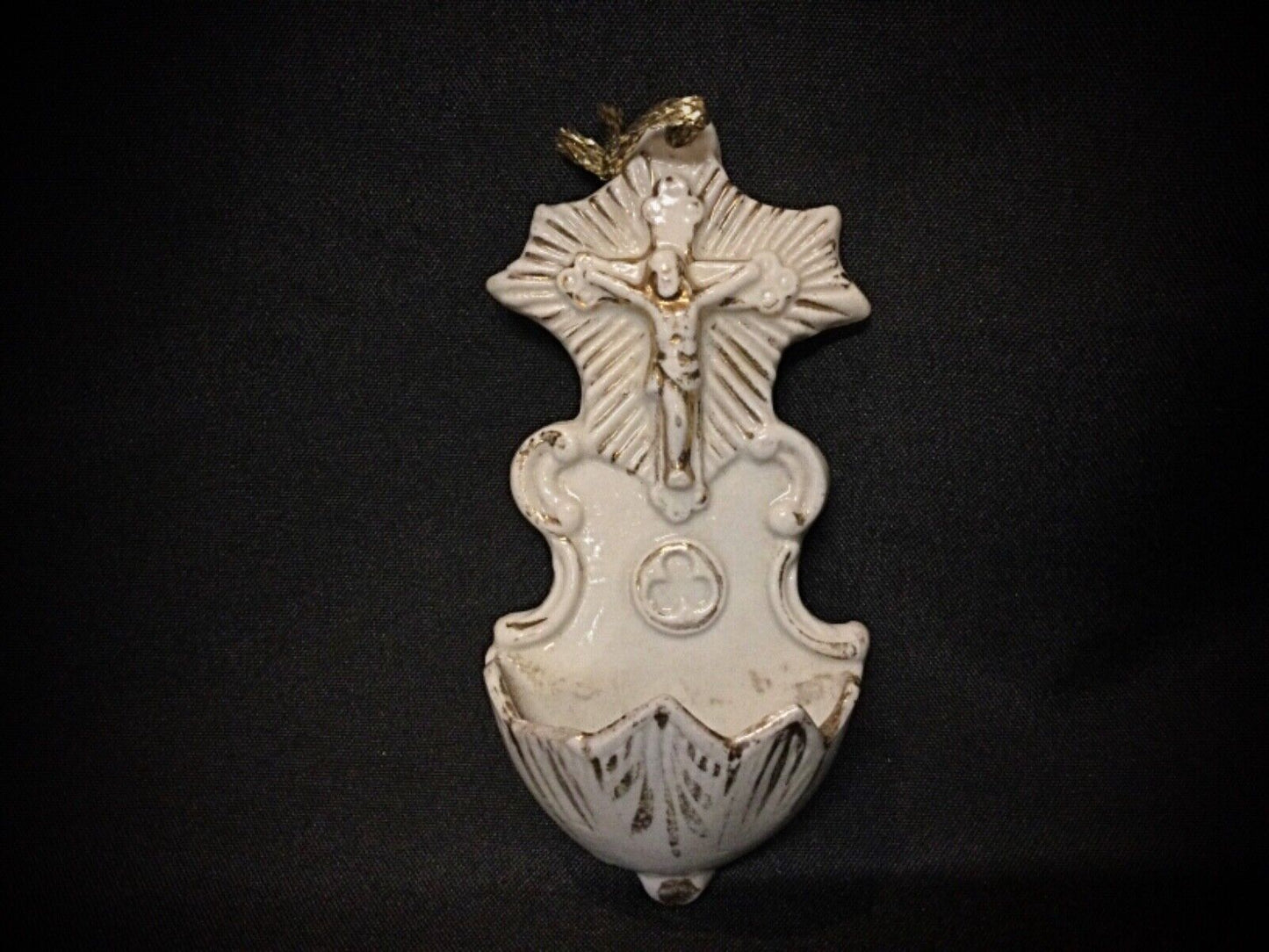 Wall-mounted porcelain Christ with partially worn gilding on the esoteric container.