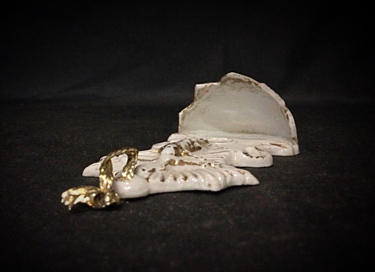Vintage small porcelain Christ showing signs of wear and unique mystical design.