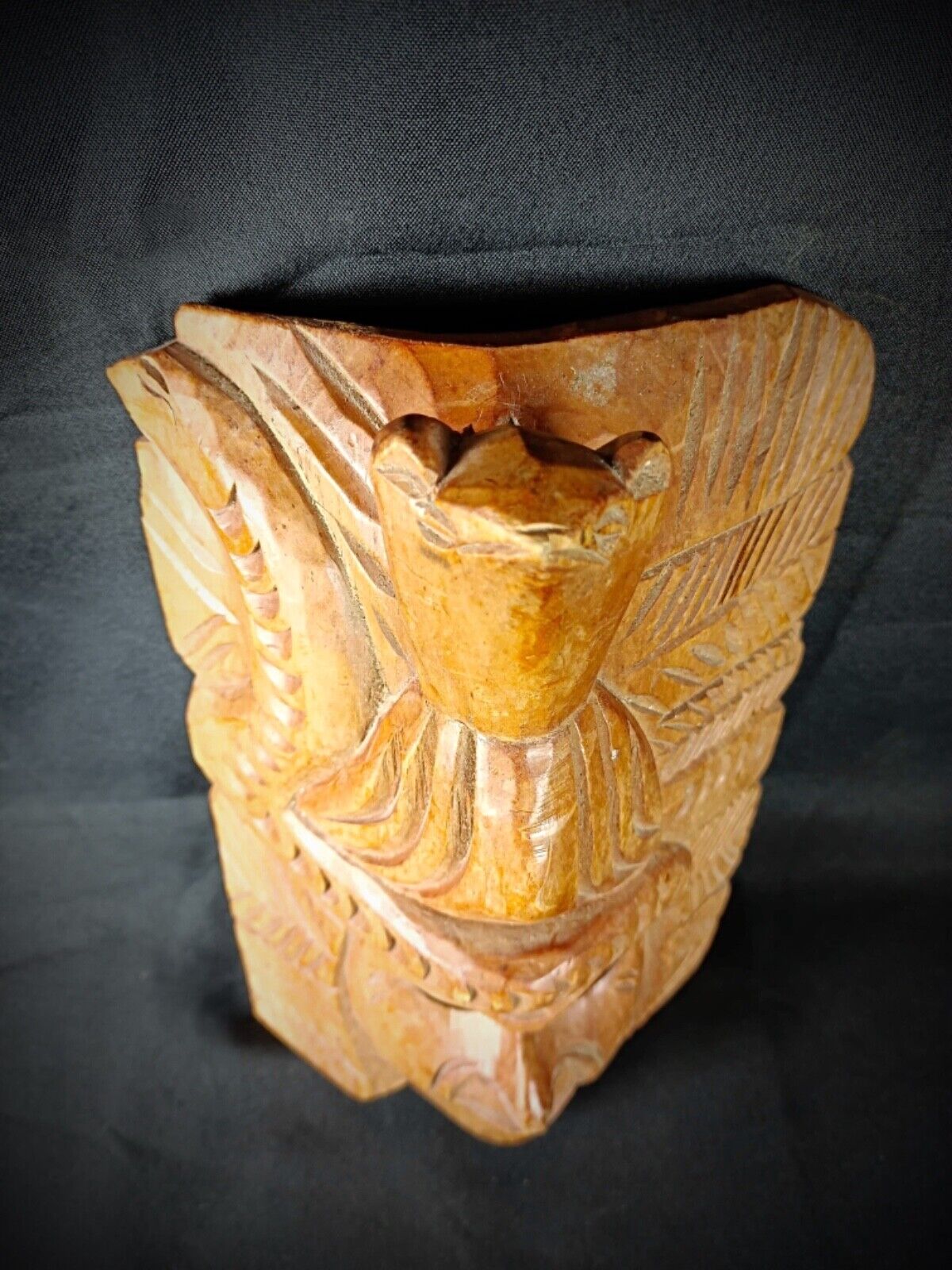 Side view of antique Maya mask showing wood texture