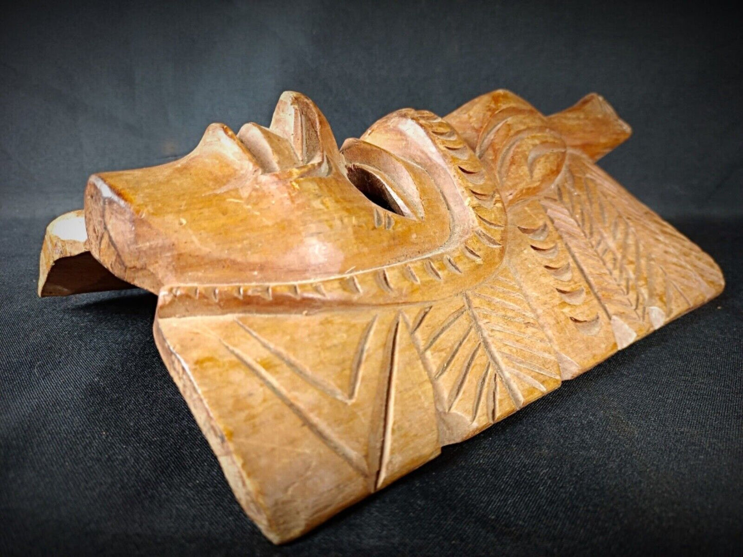 Close-up of hand-carved Maya mask’s facial expressions