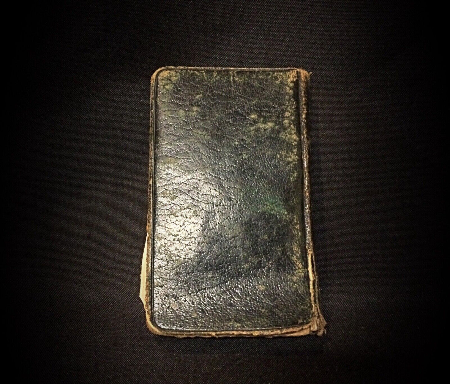 Worn cover of the antique Roman Missal, featuring intricate designs.