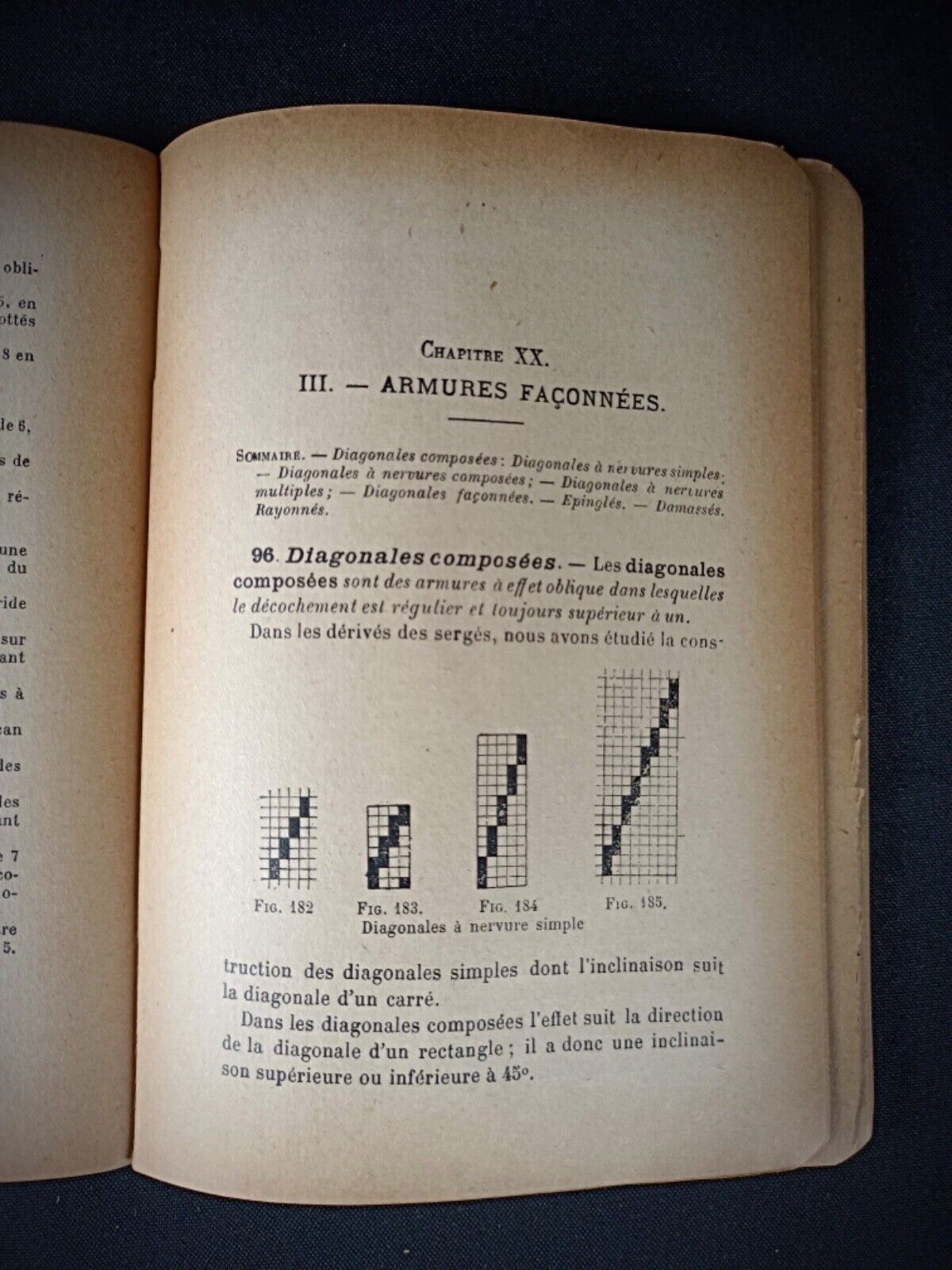 Close-up of the aged spine and worn cover of an antique textile book