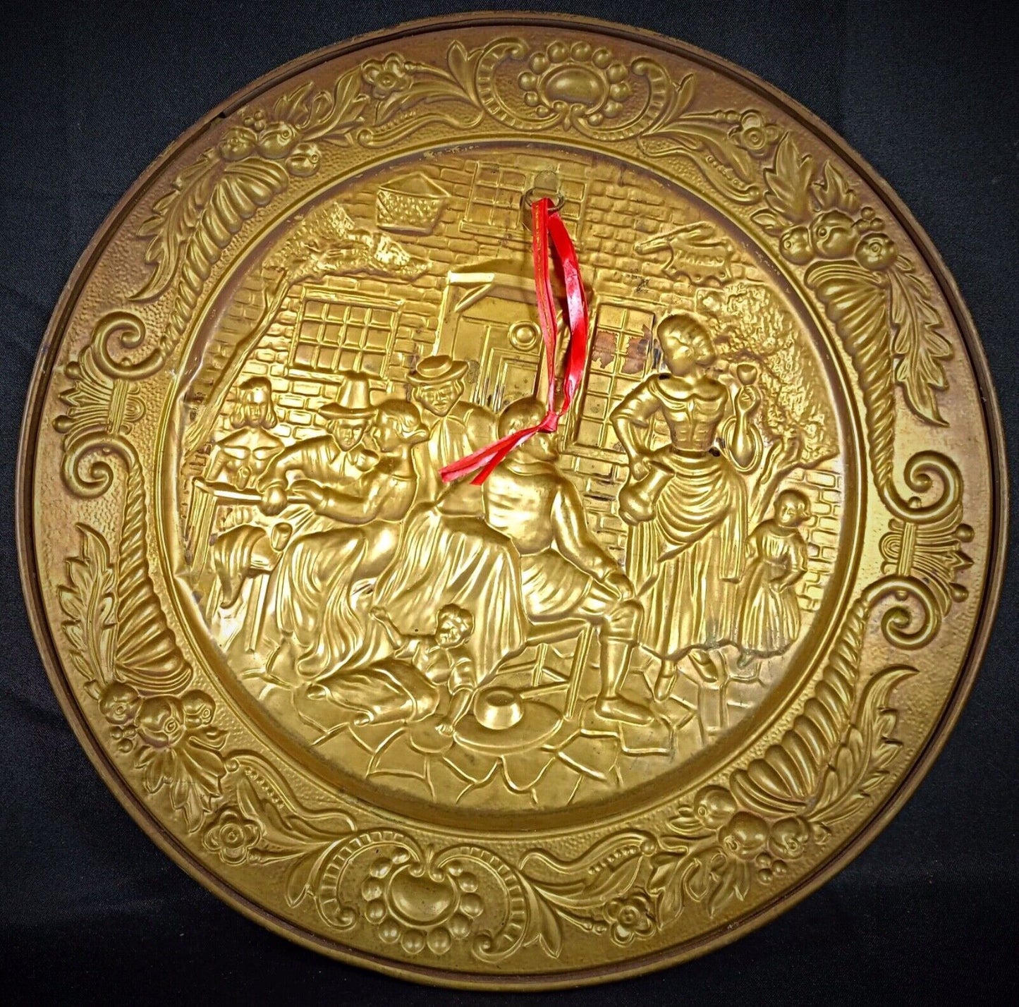 Detailed brass repoussé tavern scene — a vintage collector’s piece