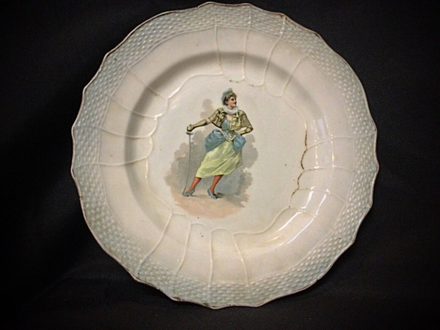 Close-up of the "Woman with a Sword" motif on the antique faience plate.