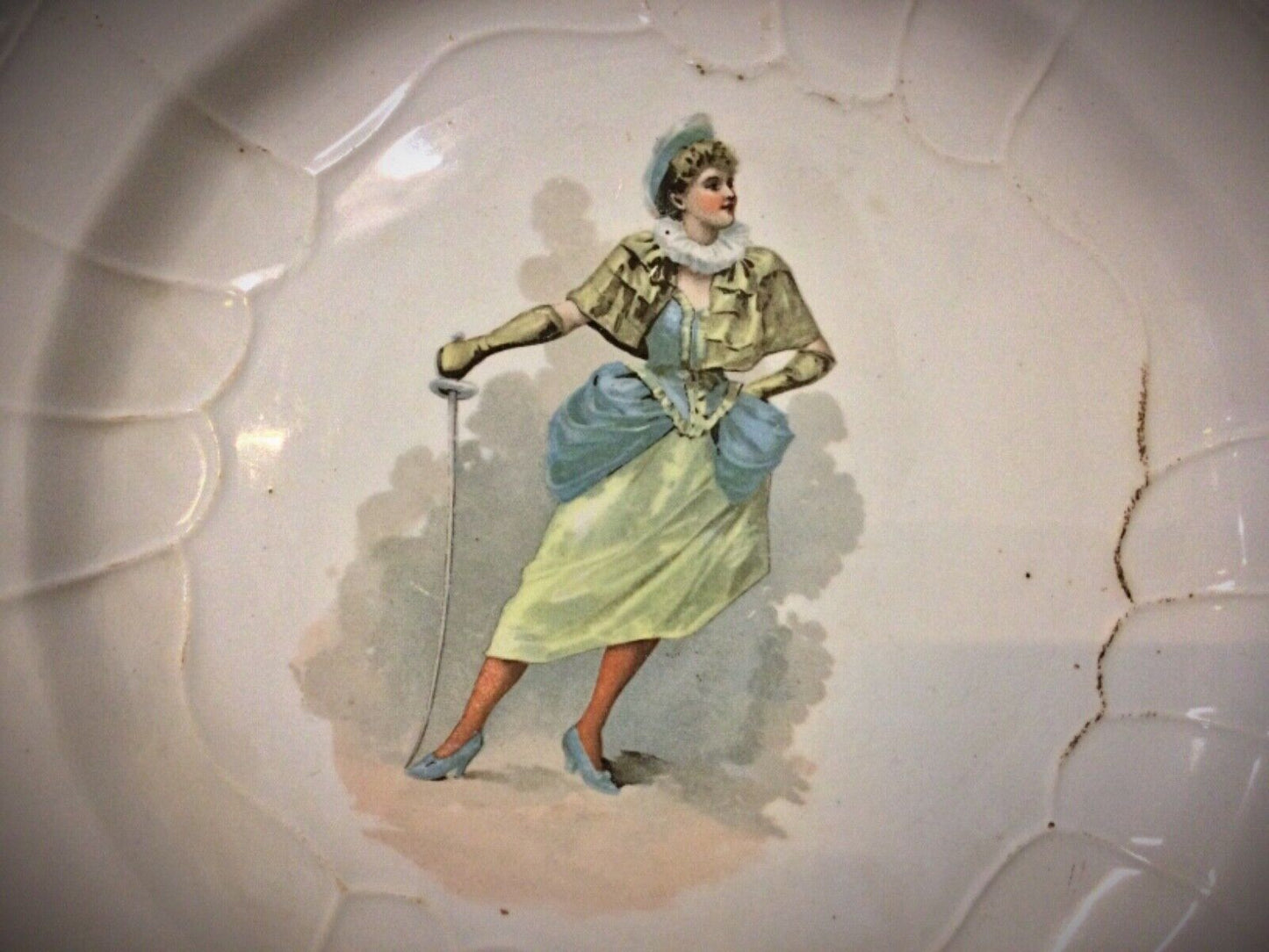 Side view of the 20th-century faience plate, showcasing its depth and glazing.