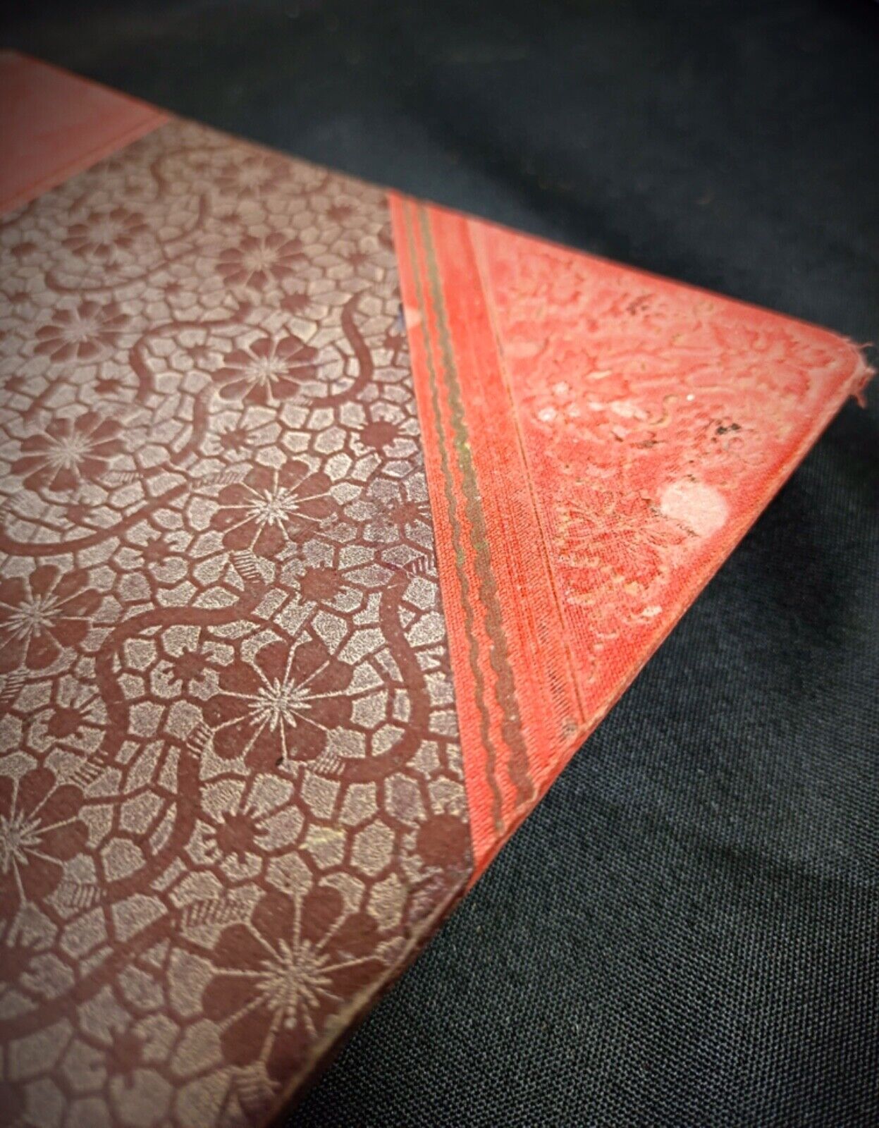 Side view of the book showing faded gilding and worn edges