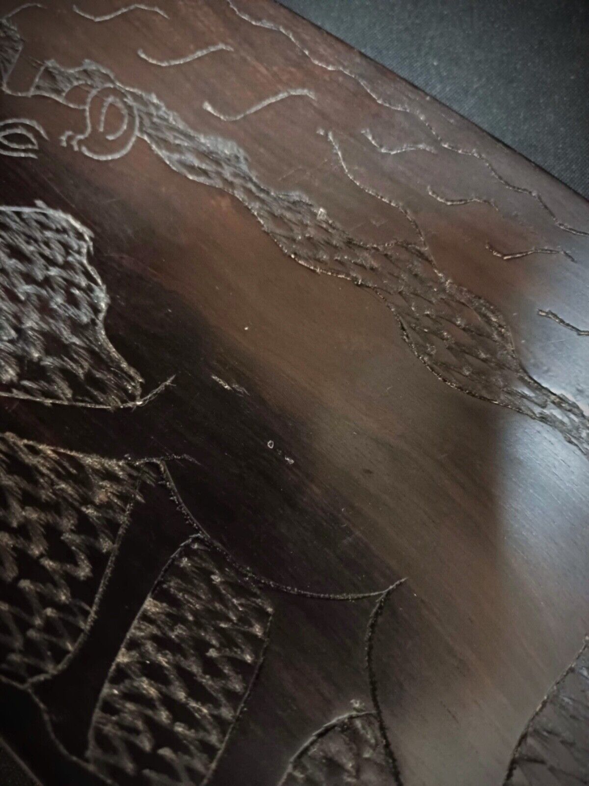 Tribal wooden tray featuring carved wildlife